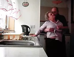 Grandma together with grandpa making out in the air the kitchenette